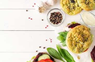 Homemade veggie burger with beetroot cutlet, spinach bun and vegetables