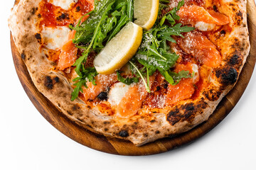 italian oven pizza with tomatoes, rucola, salmon and lemon