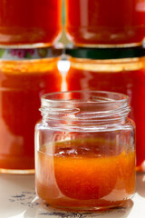 Fototapeta na wymiar Canned apricot jam in glass jars on the windowsill.