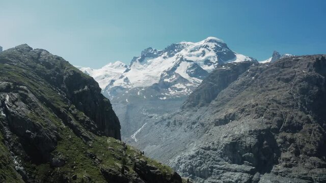 Aerial footage panning in on Breithorn mountain range in Swiss Alps