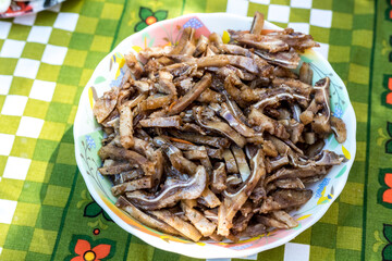 A cooked dish made from pork ears. Delicacy. The dish is on our table.