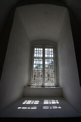 window in white stone wall with  lattice
