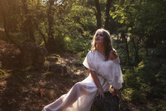 Beautiful Mystery Gothic Woman In Long White Dress In Autumn Forest.