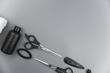 Professional hair dresser tools with copy space. Hair stylist equipment set on gray background....