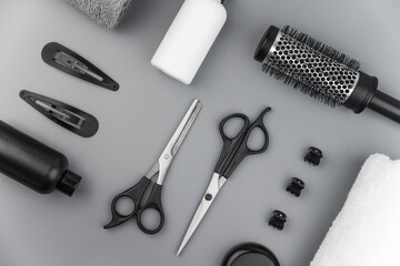 Professional hair dresser tools with copy space. Hair stylist equipment set on gray background....