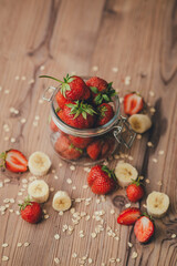 Strawberry with banana on wooden background