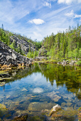 View of The Pyha-Luosto National Park in summer, rocks, stones, trees and natural pond, Lapland, Finland