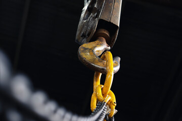 Crane hook on which chains with hooks are attached. Lifting mechanism at the factory close-up.