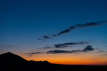 Panorama colorful magnificent sunset in countryside above hills and fields