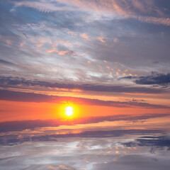 Fototapeta na wymiar Sunset over the sea with bright sun.