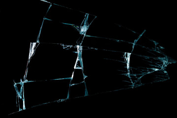 broken mirror glass on a black background in cracks in the form of an isolated image abstraction