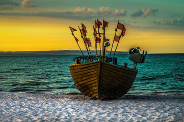Beautiful beach with fisherman boat during sunrise on ruegen island in germany at the baltic sea...