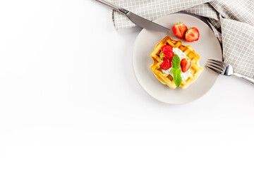 Homemade belgian waffles on served table on white background top view
