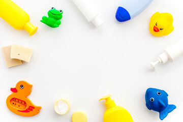 Bath cosmetics and Toy for child. Shampoo, gel, cream, soap and towel. White background top view
