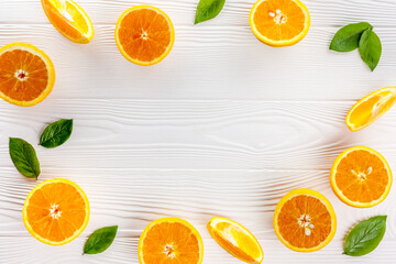 Orange slices on the on white table wooden background top view flat lay frame