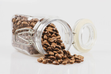 Coffee beans in a jar on white