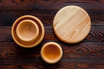 Making wooden dishes. Empty bowls on brown wooden background top view copy space