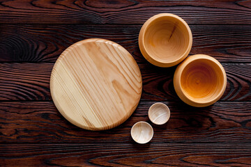 Making wooden dishes. Empty bowls on brown wooden background top view copy space