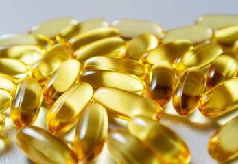 Close up fish oil capsules. Omega 3 arranged on wooden background. Copy space for your text.