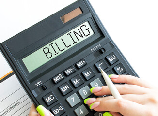 A calculator with text Billing on the display