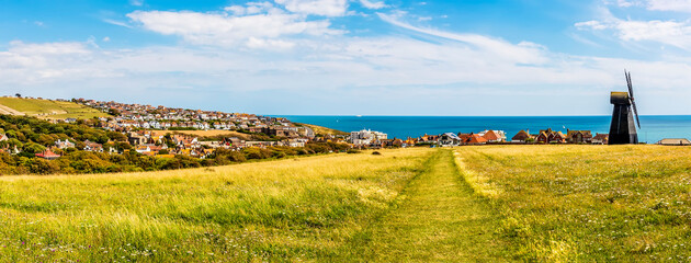 A panorama down Beacon Hill towards the town of Rottingdean, Sussex, UK in summer