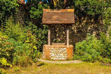 A wishing well in the town of Rottingdean, Sussex, UK in summer