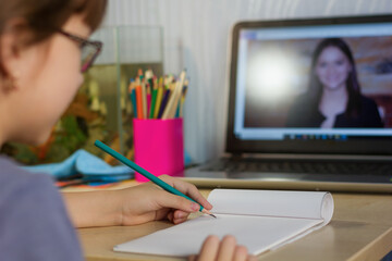 Cute girl studies at home by internet.