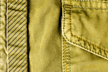 clothing items stonewashed cotton fabric texture with seams, clasps, buttons and rivets, macro