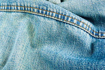 clothing items blue stonewashed faded jeans cotton fabric texture with seams, clasps, buttons and...