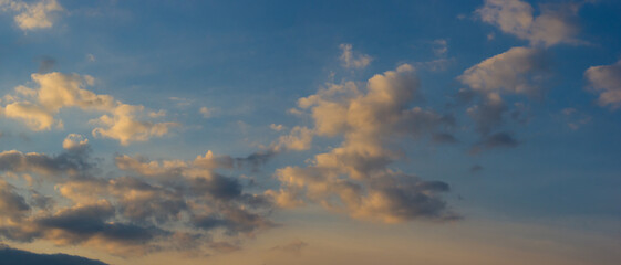 Landscape with dramatic light - beautiful golden sunset with saturated sky and clouds.