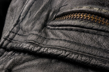 Old vintage genuine soft black leather texture background, top layer with pores and scratches,...