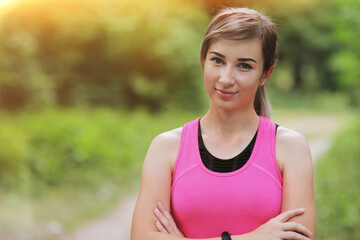 Fototapeta premium Portrait of young fitness woman in the morning forest. Healthy fit living
