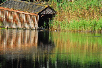Fototapeta na wymiar Africa- Beautifully Reflected Boat House on a River