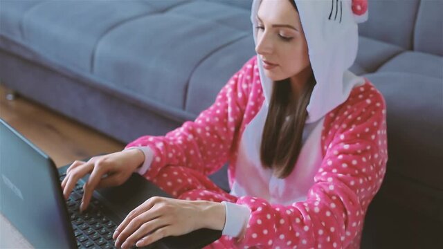 Young woman in funny pajama working from home