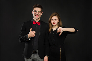 Discordance of opinions. Smiling guy votes for, girl voting against