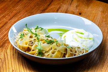 Linguine pasta with meat or mushrooms and Parmesan foam on a plate