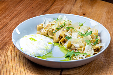 Linguine pasta with meat or mushrooms and Parmesan foam on a plate