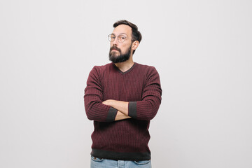  pensive young man in a burgundy sweater in the studio on a white background