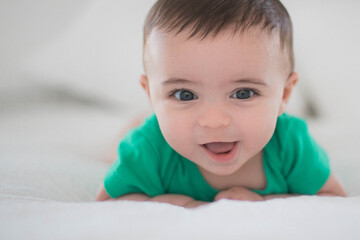 Baby in bed playing 