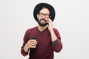 cheerful young man with a beard uses a mobile phone. close-up portrait in studio