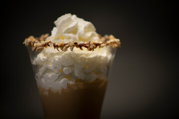 Tasty Italian coffee in a big glass. Is a typical espresso with sweet cream on the top. All with a black background