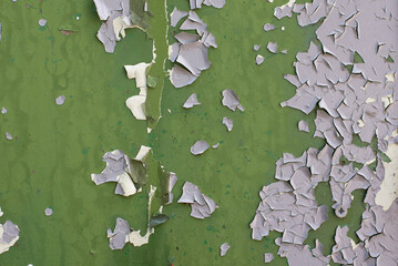 A lot of cracks on an old painted wall. Abstract grunge background