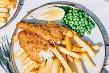 Traditional English Food such as Fish and Chips with green peas served in the Pub or Restaurant
