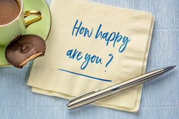 How happy are you? Handwriting on a napkin with a cup of coffee. Happiness, mindset and personal...