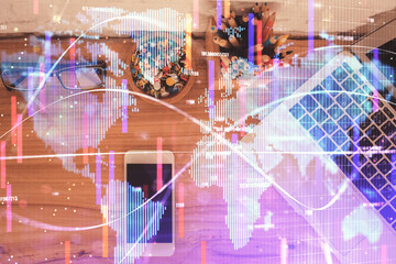 Double exposure of business theme hologram over desktop with phone. Top view. Mobile international trade connection concept.