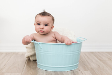 Baby playing in a bucket 