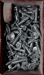 a set of various screws and anchor bolts for installation repair and maintenance close up. Motion...