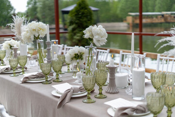 Decorated wedding table, white peonies and feathers. Chiavari chairs are at the table-3.