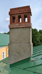 a brick ventilation duct runs through the green roof