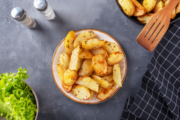 Baked potato with thyme on a plate. Top view
